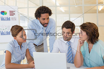 Concentrated business people using laptop at office