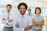 Smiling young businessman with colleagues in office