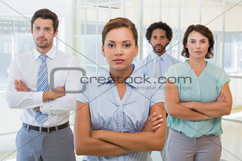 Serious businesswoman with colleagues in office