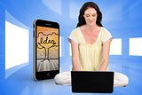 Composite image of happy woman using a laptop