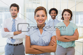 Smiling businesswoman with colleagues in office