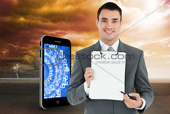 Composite image of businessman pointing with pen on clipboard