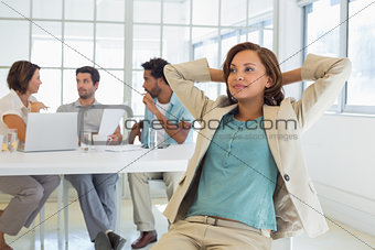 Relaxed businesswoman with colleagues in meeting