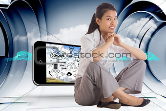 Composite image of smiling businesswoman sitting with hands together