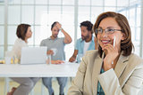 Smiling businesswoman with colleagues in meeting