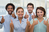 Business colleagues gesturing thumbs up