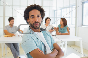 Portrait of a serious businessman with colleagues in meeting