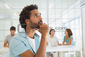Close-up of serious businessman with colleagues in meeting