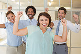 Cheerful business colleagues cheering in office