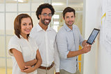 Portrait of business people with digital tablet in office