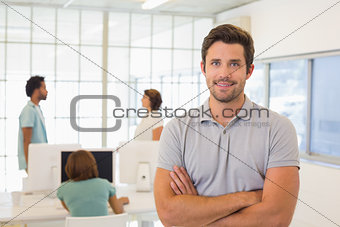 Portrait of a smiling businessman with colleagues in meeting