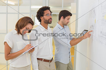 Concentrated business people using digital tablet in meeting