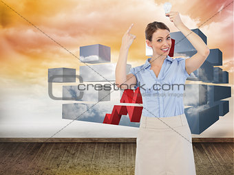 Composite image of classy businesswoman holding light bulb above her head