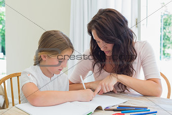Woman assisting daughter in homework