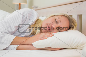 Woman sleeping in bed at home