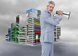 Composite image of furious businessman posing with loudspeaker