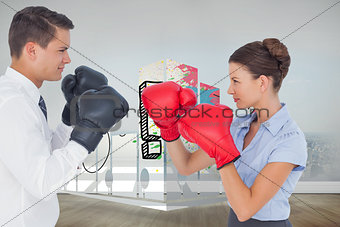 Composite image of colleagues in competition having a boxing match