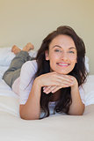 Confident woman smiling while in bed