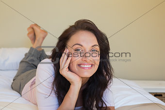 Happy woman lying in bed