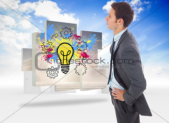 Composite image of serious businessman standing with hands on hips