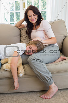 Mother looking at daughter sleeping on her lap