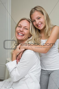 Loving girl with mother in house