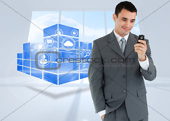 Composite image of smiling businessman looking at his cellphone