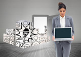 Composite image of businesswoman looking at laptop in her hands