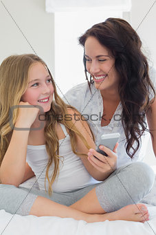Mother and daughter with mobile phone