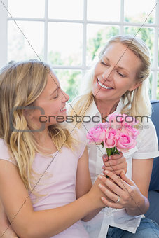 Mother receiving flower bouquet from daughter