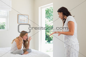 Mother and daughter arguing in bedroom