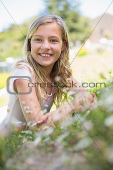 Happy girl lying on grass in park