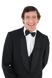 Portrait of groom in tuxedo smiling