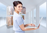 Composite image of cheerful businesswoman using a laptop