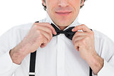 Man adjusting bow tie
