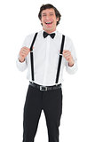 Cheerful groom wearing suspenders