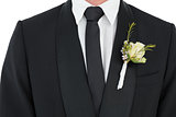Groom wearing tuxedo with corsage