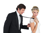 Bride pulling grooms tie