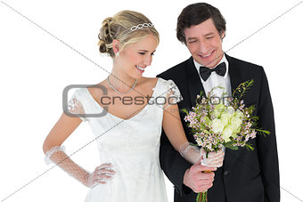 Loving newlywed couple holding bouquet