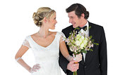 Newlywed couple with bouquet looking at each other