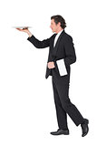 Waiter in suit carrying tray over white background
