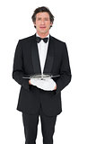 Waiter holding empty tray over white background
