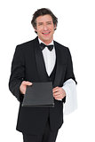 Confident waiter giving bill pad over white background