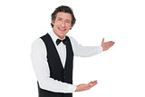 Happy waiter welcoming over white background