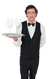 Server carrying wine glasses over white background