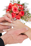 Cropped image of bride and groom exchanging ring