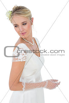 Bride looking over shoulder against white background