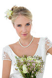 Bride with bouquet against white background
