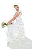Happy bride holding bouquet over white background
