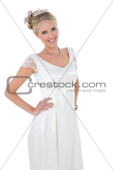 Bride with hands on waist against white background